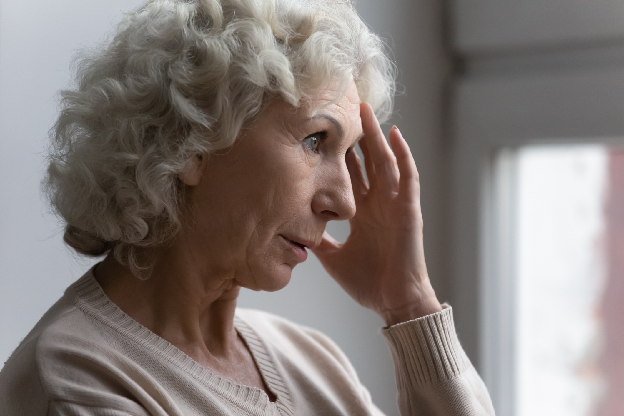 Confused worried old lady suffering from age disorders