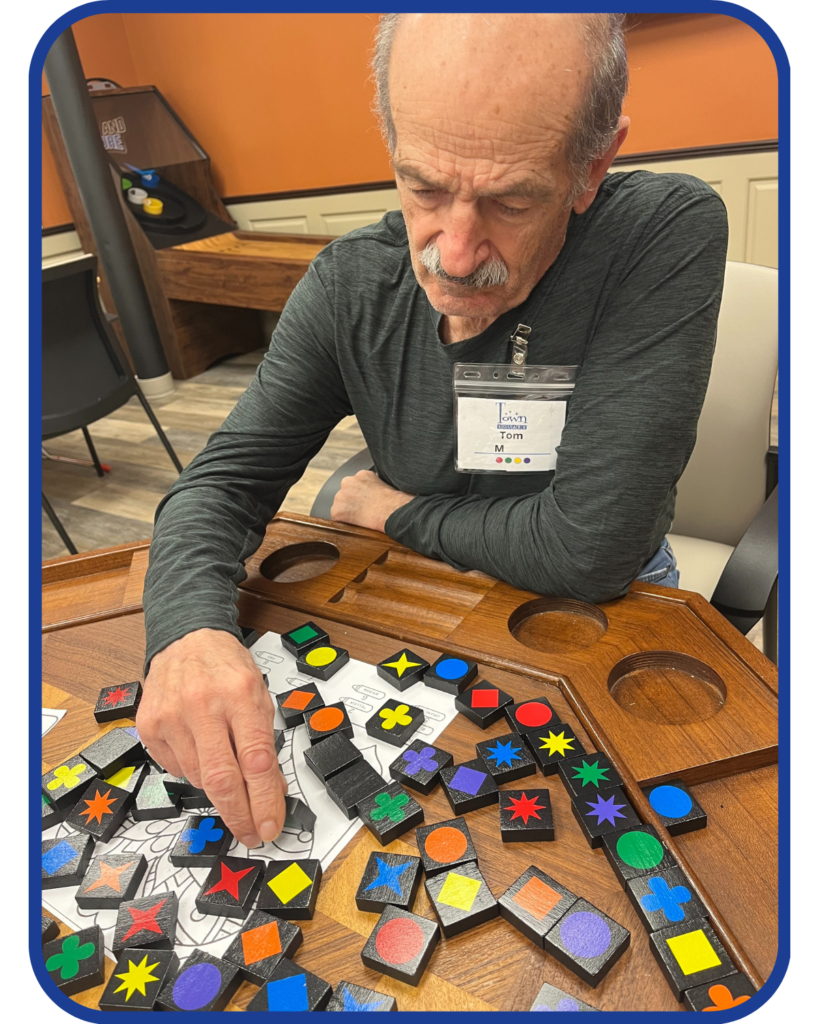 Older Male adult playing a matching game.